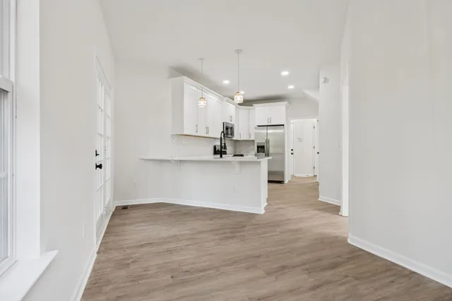 a kitchen with stainless steel appliances a refrigerator stove and microwave