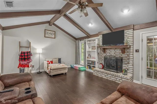 a living room with furniture fireplace and flat screen tv
