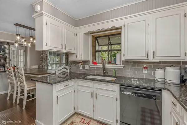 a kitchen with stainless steel appliances granite countertop a sink and cabinets