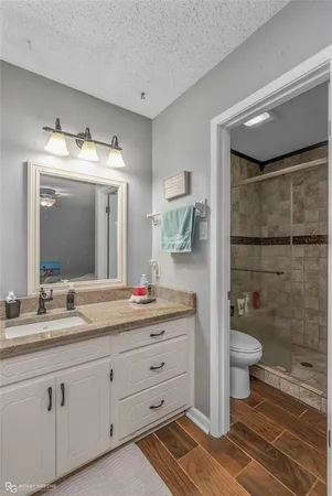 a bathroom with a double vanity sink mirror and toilet