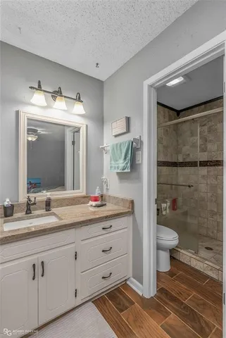 a bathroom with a double vanity sink mirror and toilet