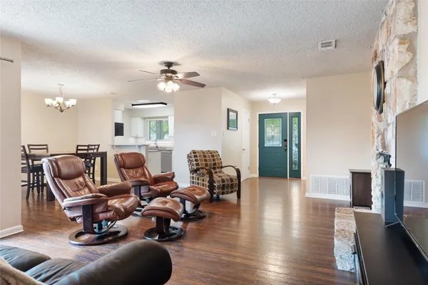 a kitchen with stainless steel appliances a sink a stove a microwave a refrigerator and cabinets