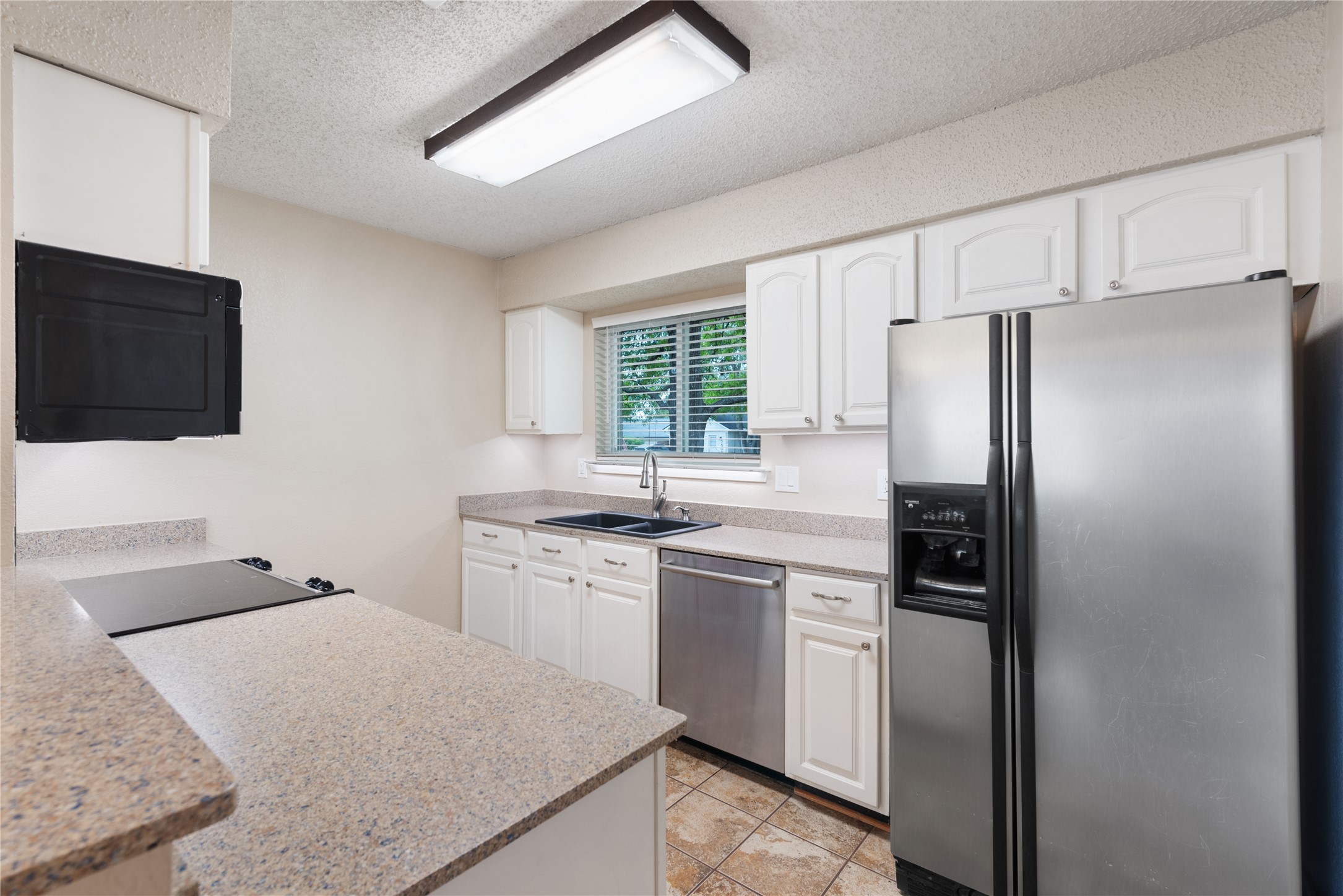 3608 Cookstown Drive Austin, TX 78759 - Photo 6 of 22 a kitchen with a refrigerator stove and sink