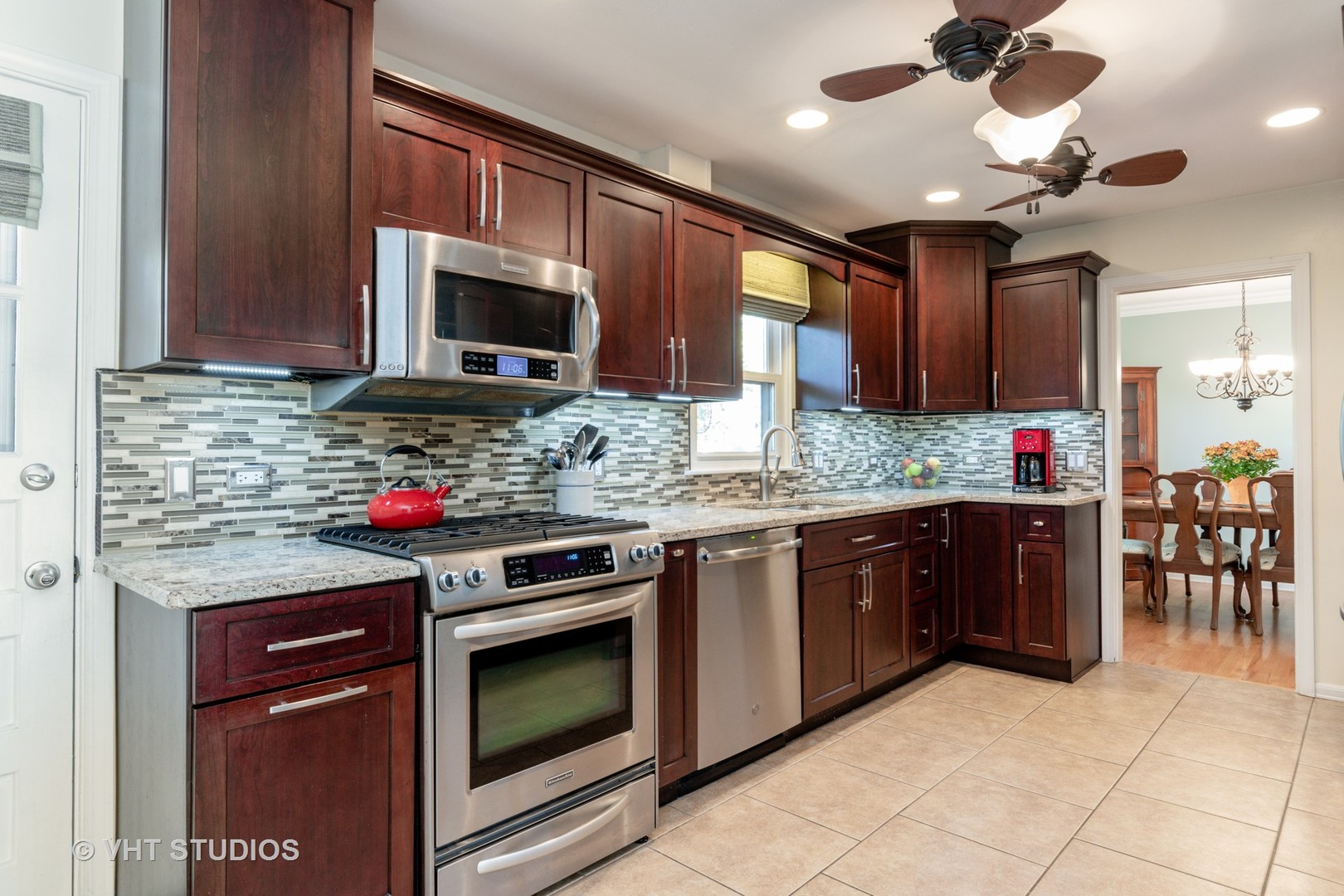 305 West Gartner Road Naperville, IL 60540 - Photo 7 of 20 a kitchen with stainless steel appliances granite countertop a stove microwave and cabinets