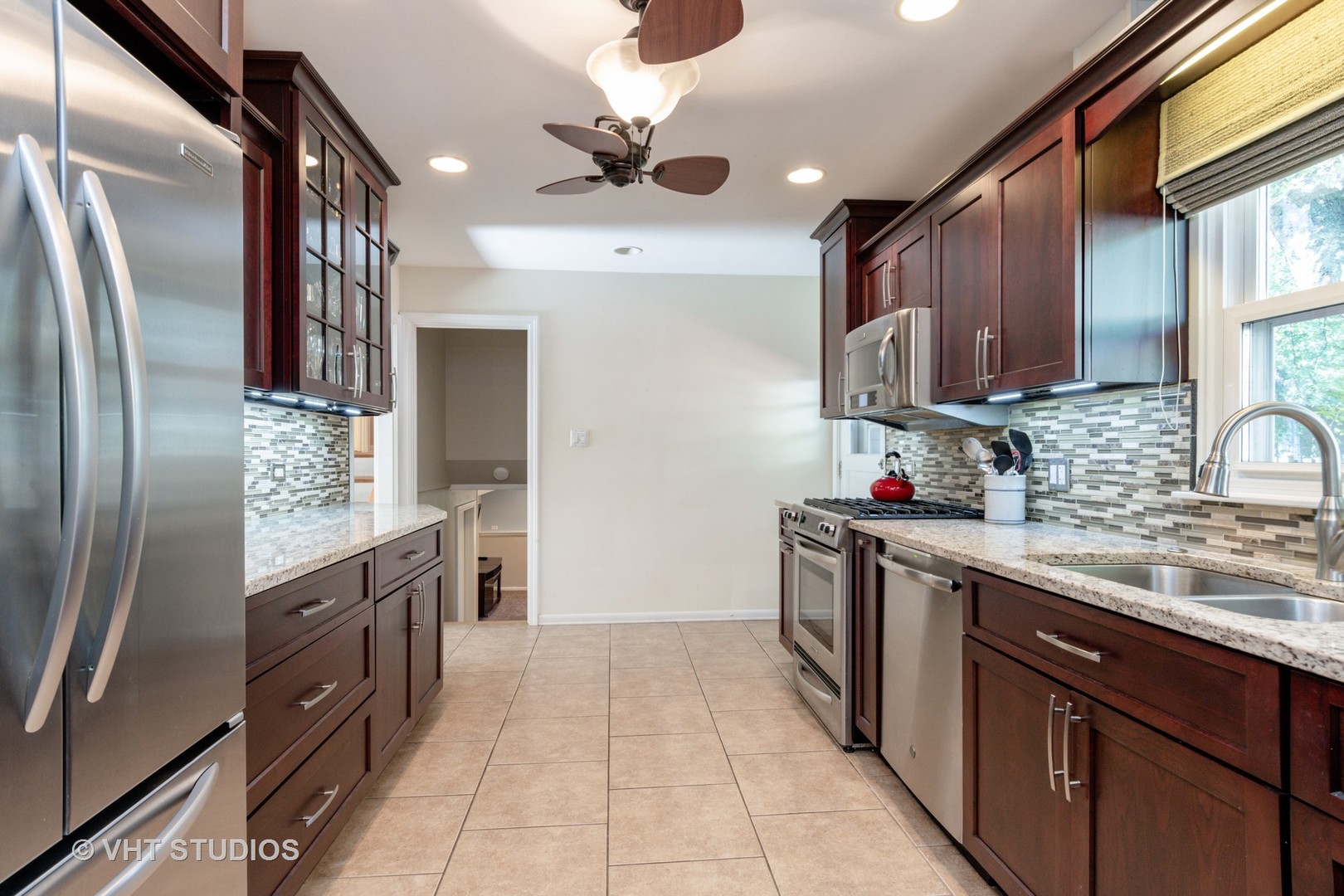 305 West Gartner Road Naperville, IL 60540 - Photo 8 of 20 a kitchen with stainless steel appliances granite countertop a refrigerator a sink a stove top oven and cabinets