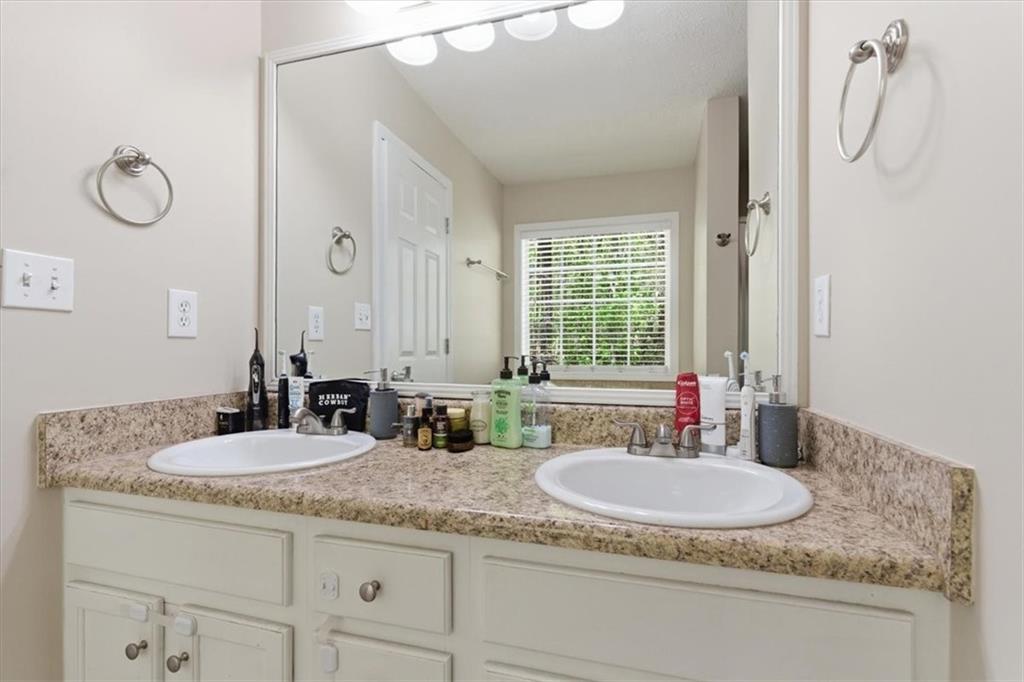 101 Brookcliff Court Temple, GA 30179 - Photo 21 of 48 a bathroom with a granite countertop sink and a mirror