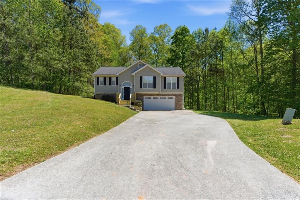 101 Brookcliff Court Temple, GA 30179 - Photo 35 of 48 a front view of a house with a yard and trees