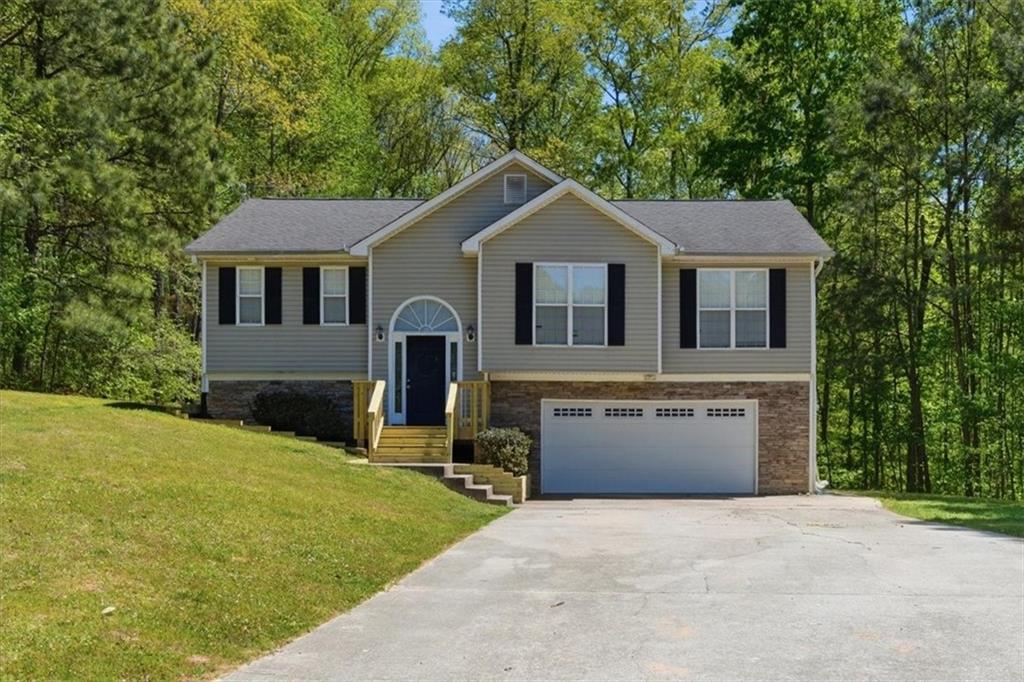 101 Brookcliff Court Temple, GA 30179 - Photo 36 of 48 a front view of a house with a yard and garage