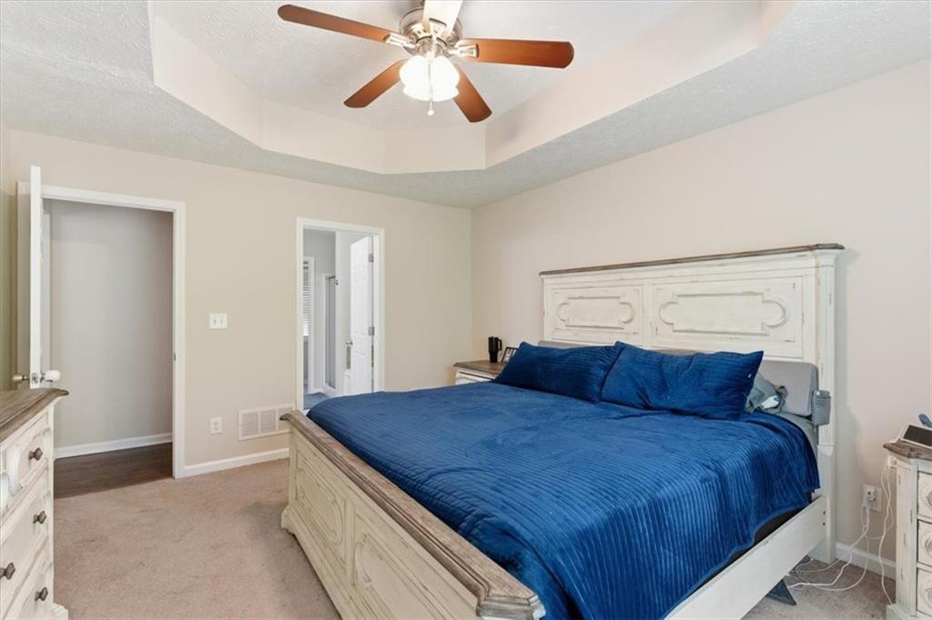 101 Brookcliff Court Temple, GA 30179 - Photo 6 of 48 a bedroom with a large bed and a chandelier