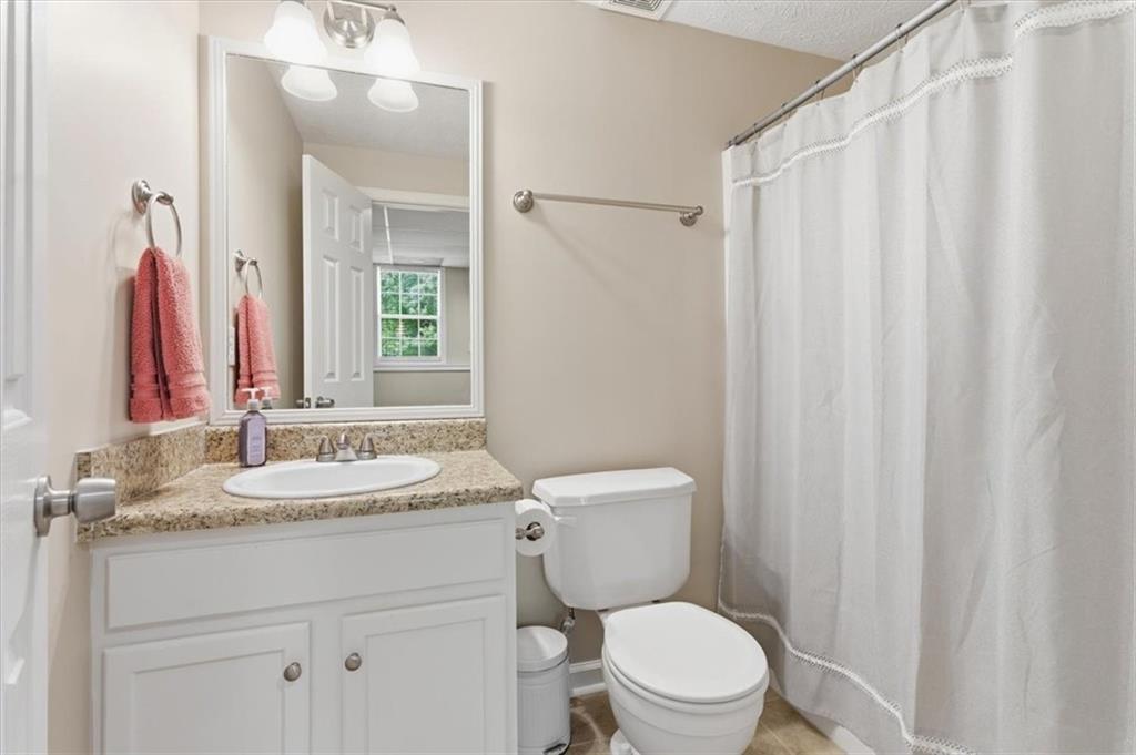 101 Brookcliff Court Temple, GA 30179 - Photo 10 of 48 a bathroom with a granite countertop sink vanity mirror and toilet
