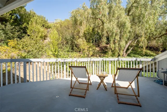 a bathroom with a double vanity sink a toilet a mirror and shower