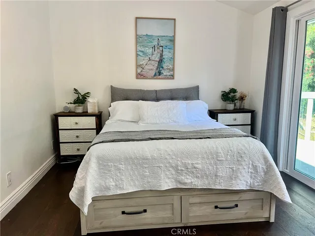 a spacious bedroom with a bed and a table in it