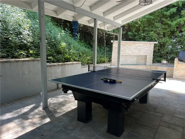 a view of a patio with couches table and chairs and potted plants