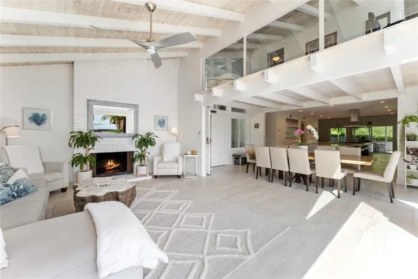 a living room with furniture a fireplace and a table