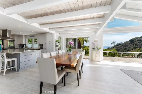 a dining room with furniture and a floor to ceiling window