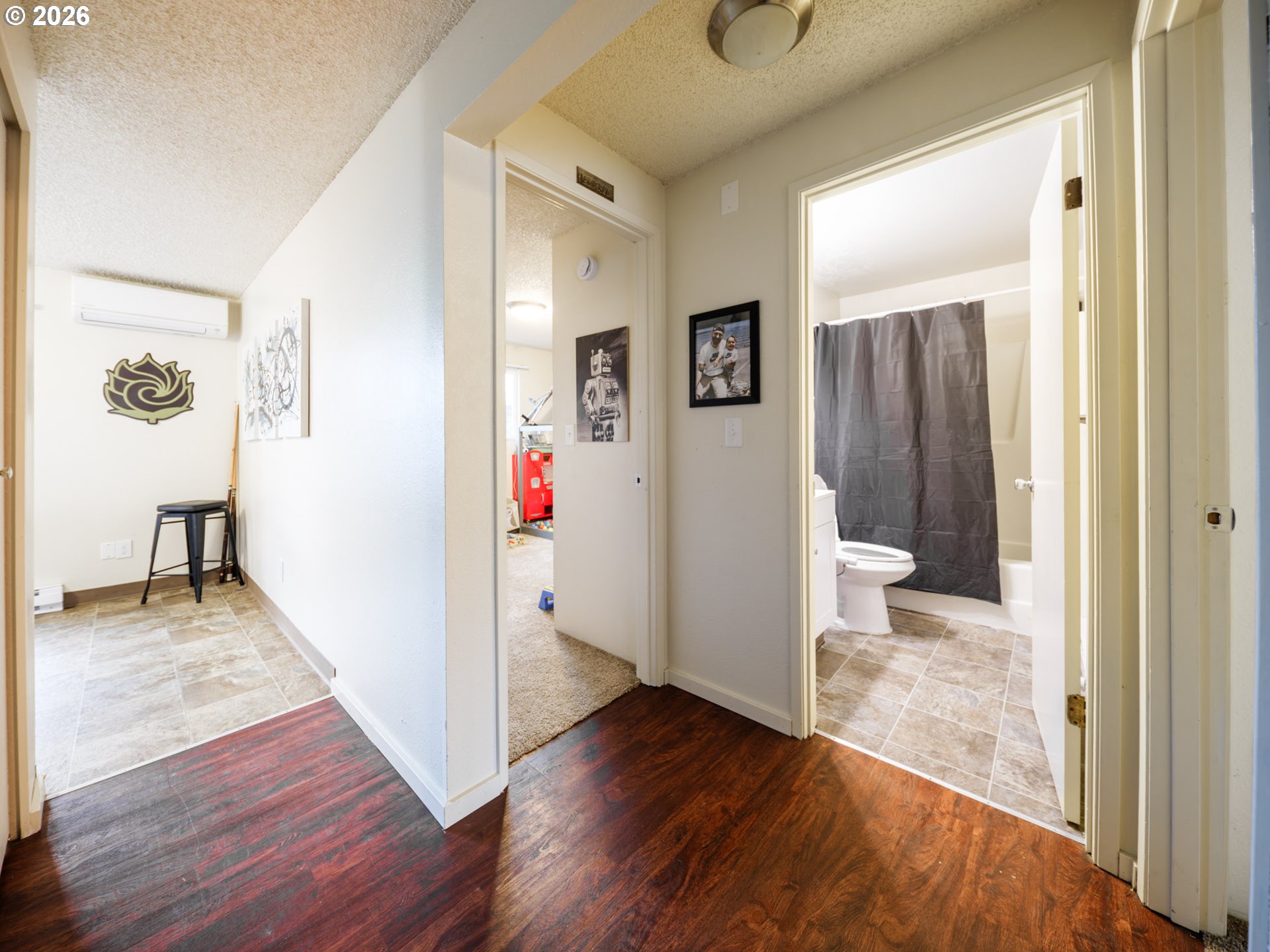 340 South Locust Street Canby, OR 97013 - Photo 11 of 21 a view of a hallway with bathroom and wooden floor