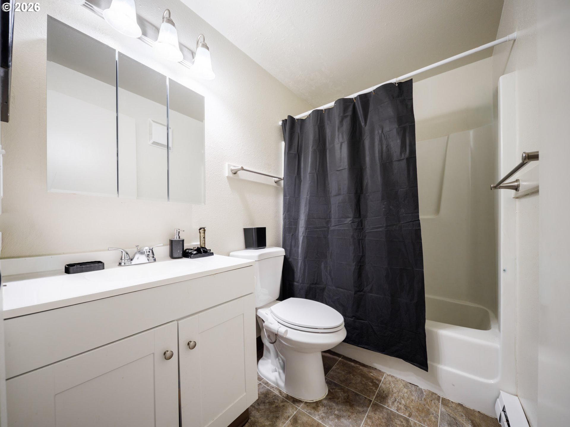 340 South Locust Street Canby, OR 97013 - Photo 7 of 21 a bathroom with a sink a toilet a mirror and shower