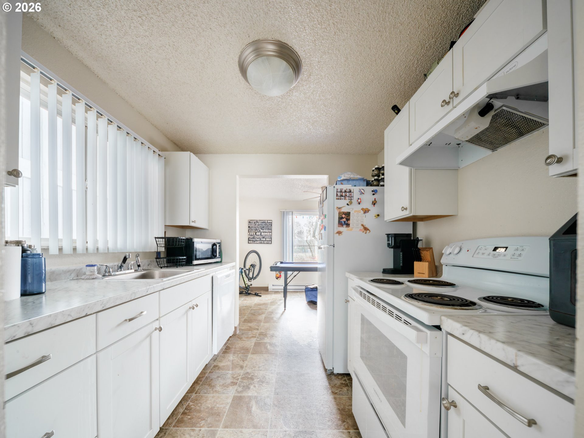 340 South Locust Street Canby, OR 97013 - Photo 10 of 21 a kitchen with stainless steel appliances a sink a stove and cabinets