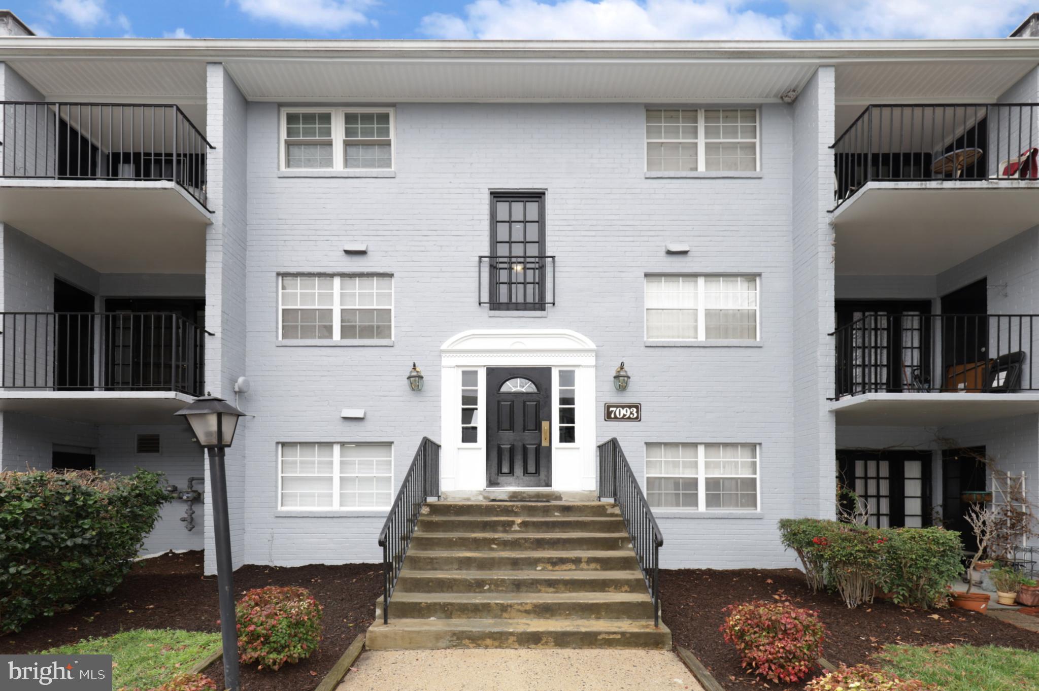 7093 Spring Garden Drive, Unit 101 Springfield, VA 22150 - Photo 1 of 23 a front view of a house with a garden