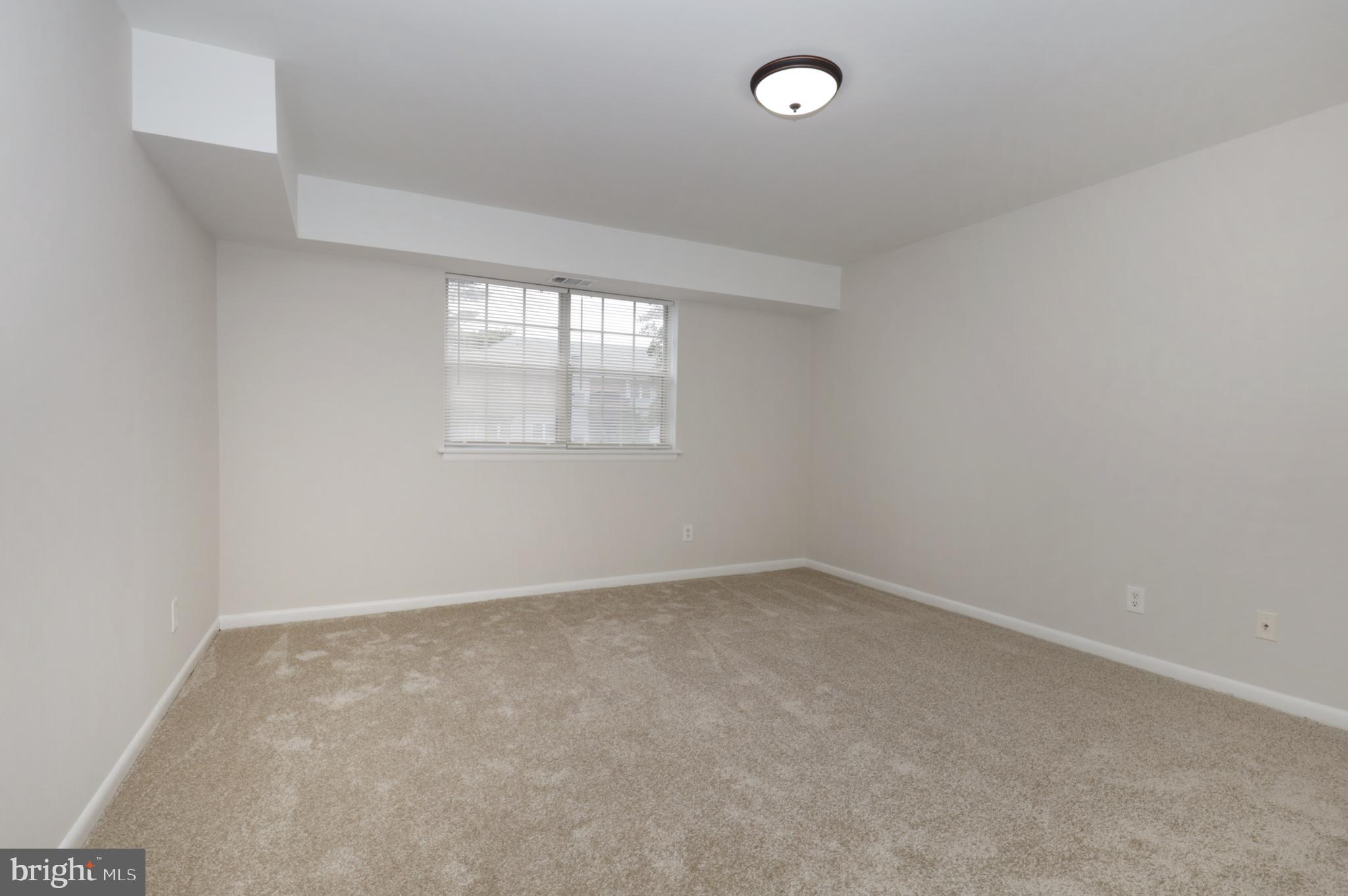 7093 Spring Garden Drive, Unit 101 Springfield, VA 22150 - Photo 15 of 23 an empty room with a window