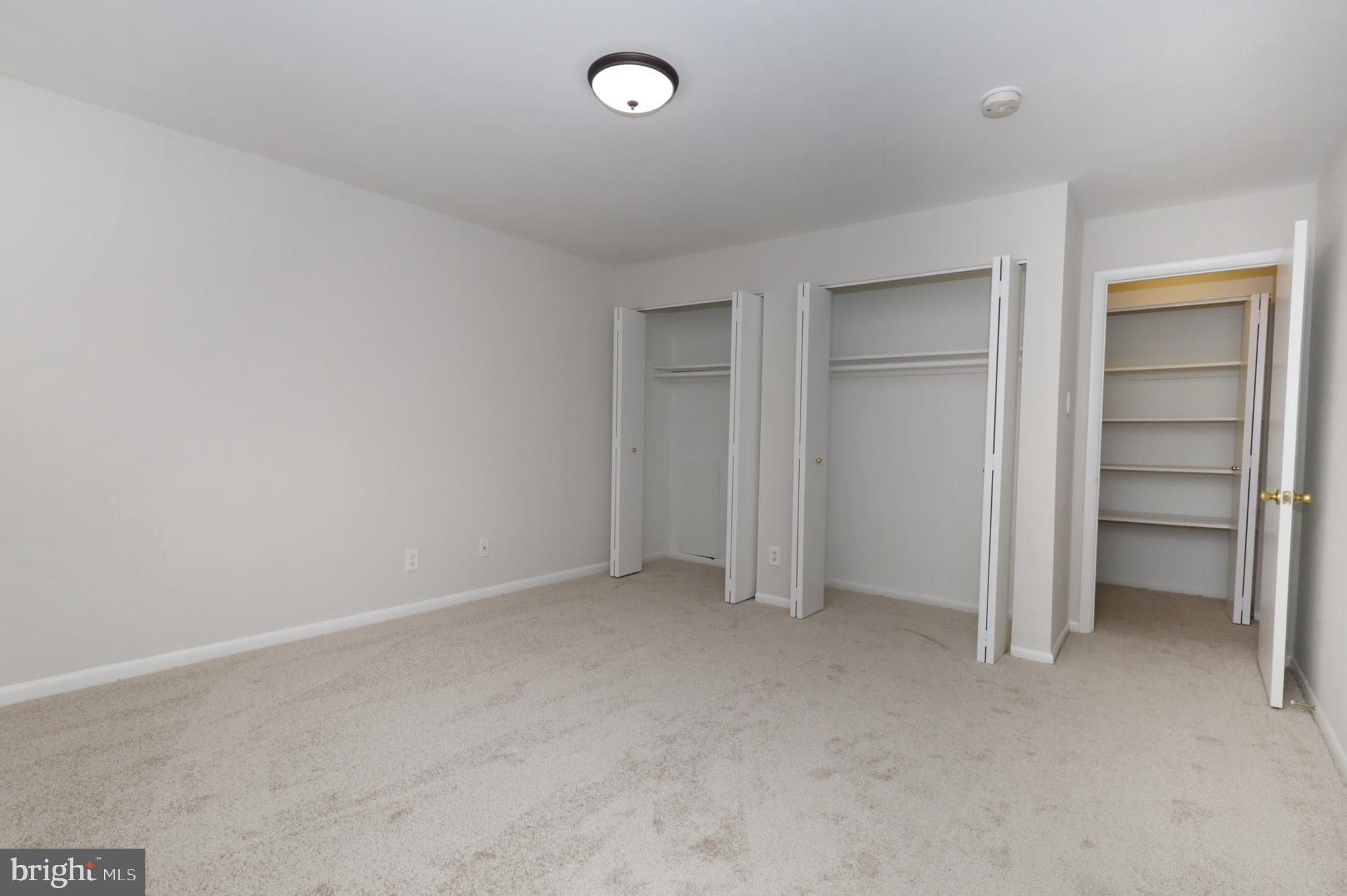 7093 Spring Garden Drive, Unit 101 Springfield, VA 22150 - Photo 17 of 23 a view of an empty room and closet area