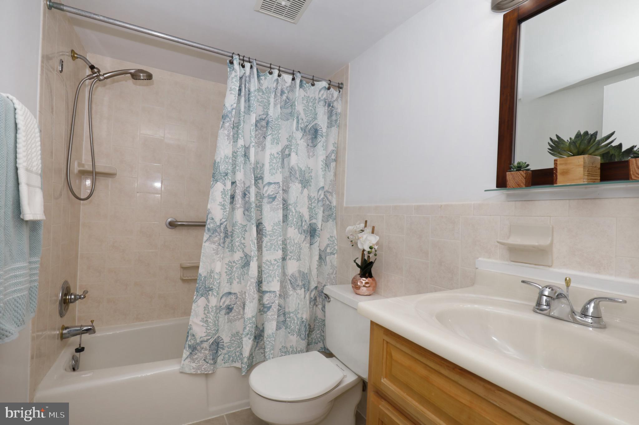 7093 Spring Garden Drive, Unit 101 Springfield, VA 22150 - Photo 18 of 23 a bathroom with a sink toilet and shower