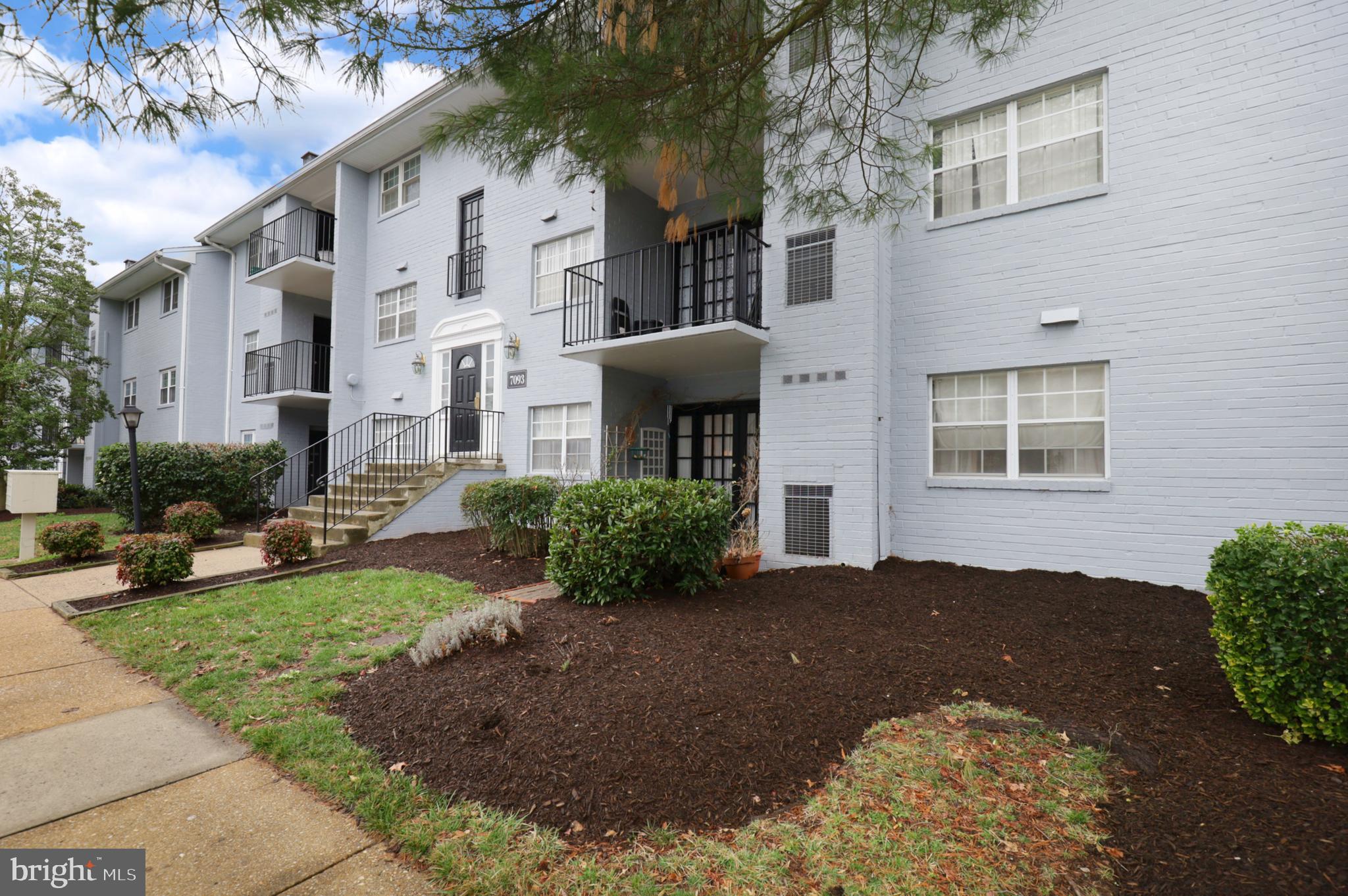 7093 Spring Garden Drive, Unit 101 Springfield, VA 22150 - Photo 3 of 23 a front view of a house with garden