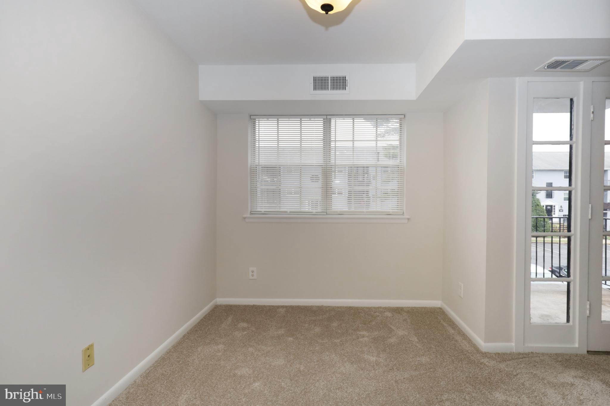7093 Spring Garden Drive, Unit 101 Springfield, VA 22150 - Photo 10 of 23 an empty room with windows