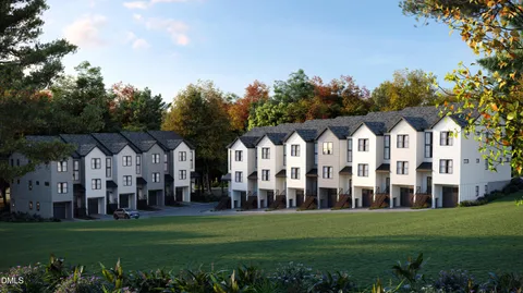 a view of a white house with a yard