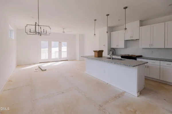 a kitchen with granite countertop white cabinets white appliances and granite countertops