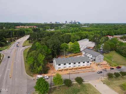 a car parked in front of a white house
