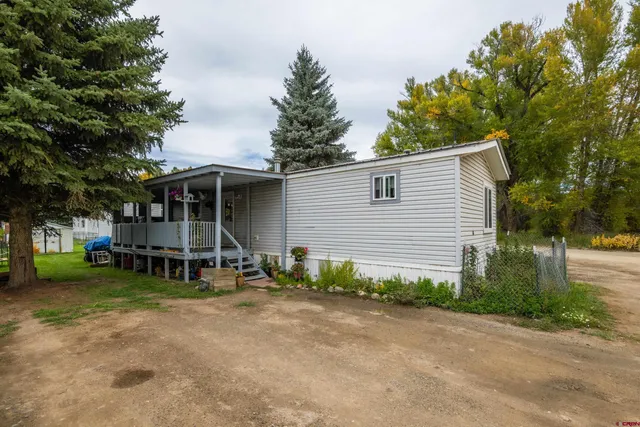 a view of a house with a yard and sitting area
