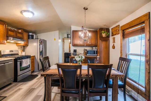 a view of a dining room with furniture window and wooden floor