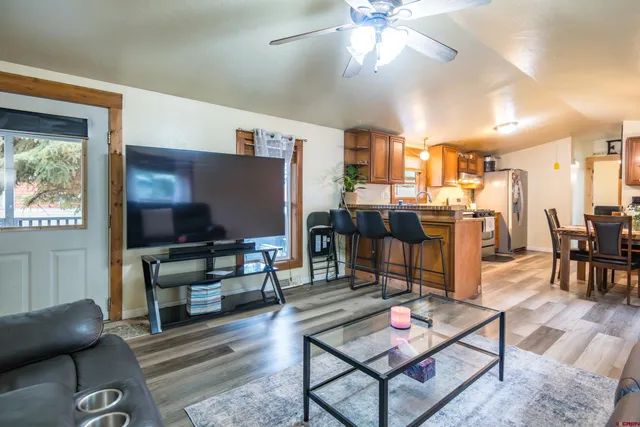 a living room with lots of furniture and kitchen view