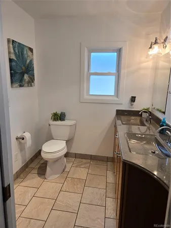 a bathroom with a sink toilet and vanity