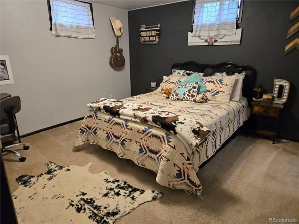 a bedroom with a bed and painting on the wall