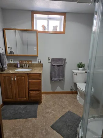 a bathroom with a sink a toilet and mirror