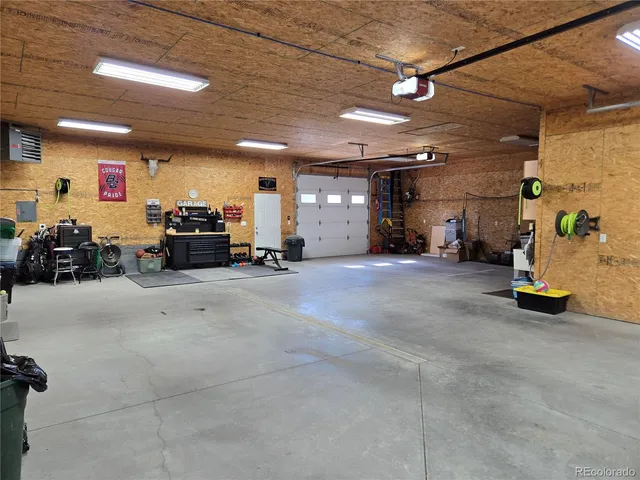 a view of a patio with table and chairs potted plants and large tree