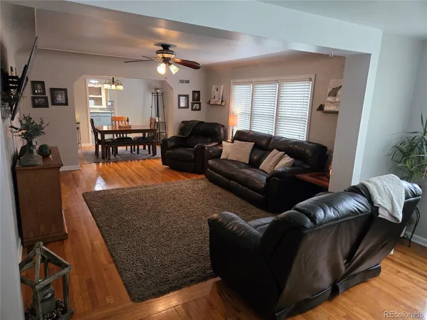 a living room with furniture and wooden floor