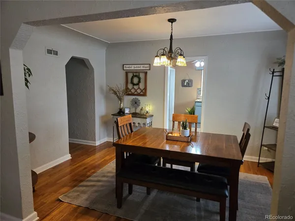 a view of a dining room with furniture and wooden floor