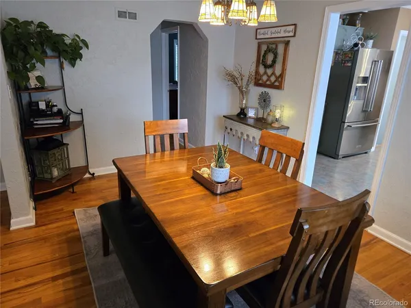 a view of a dining room with furniture and wooden floor