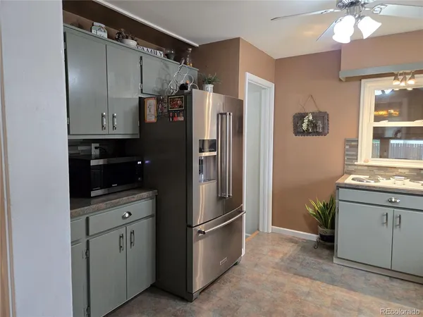 a kitchen with stainless steel appliances granite countertop a refrigerator and a sink