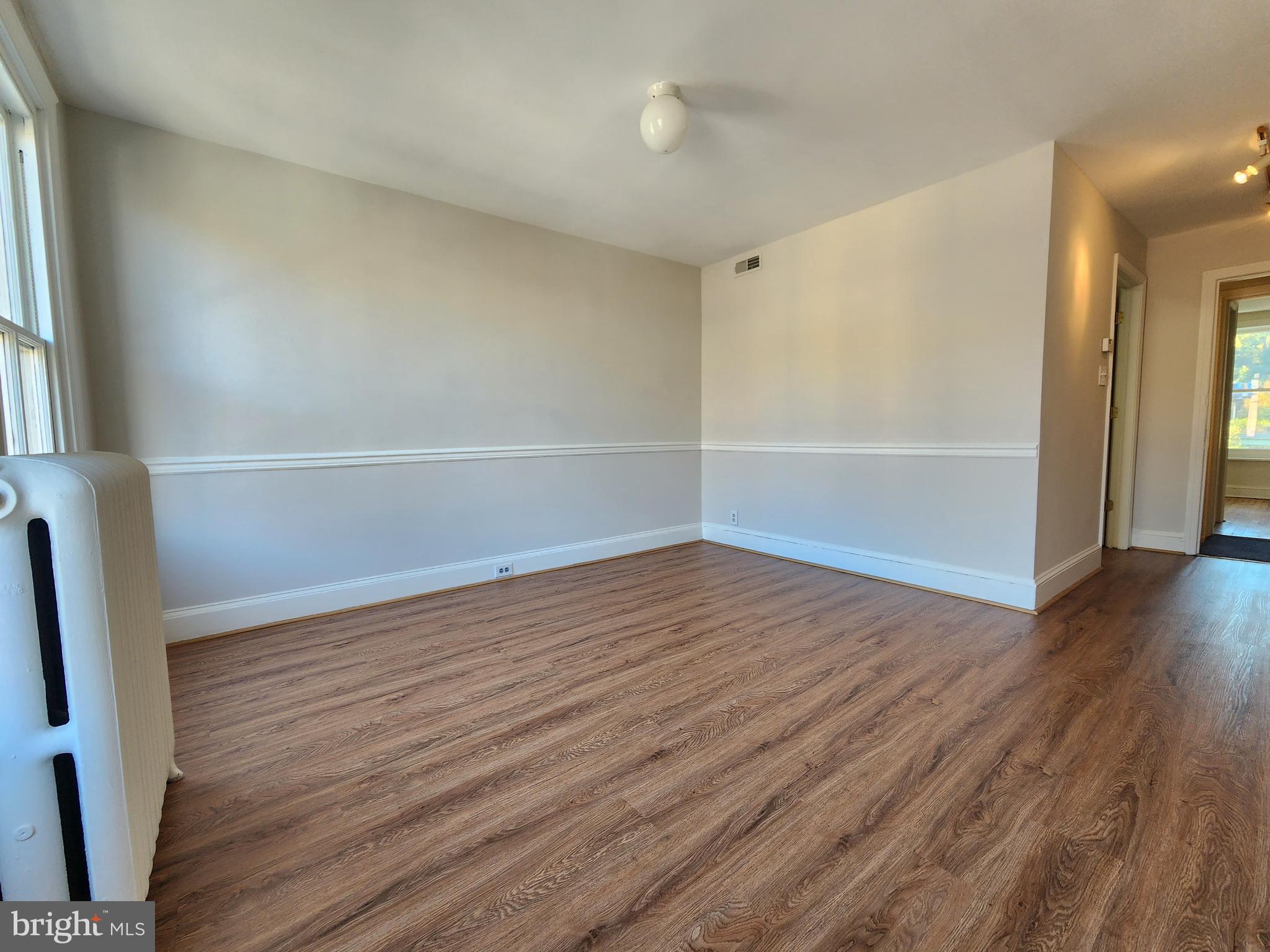4322 Main Street, Unit 2 Philadelphia, PA 19127 - Photo 23 of 27 an empty room with wooden floor and windows
