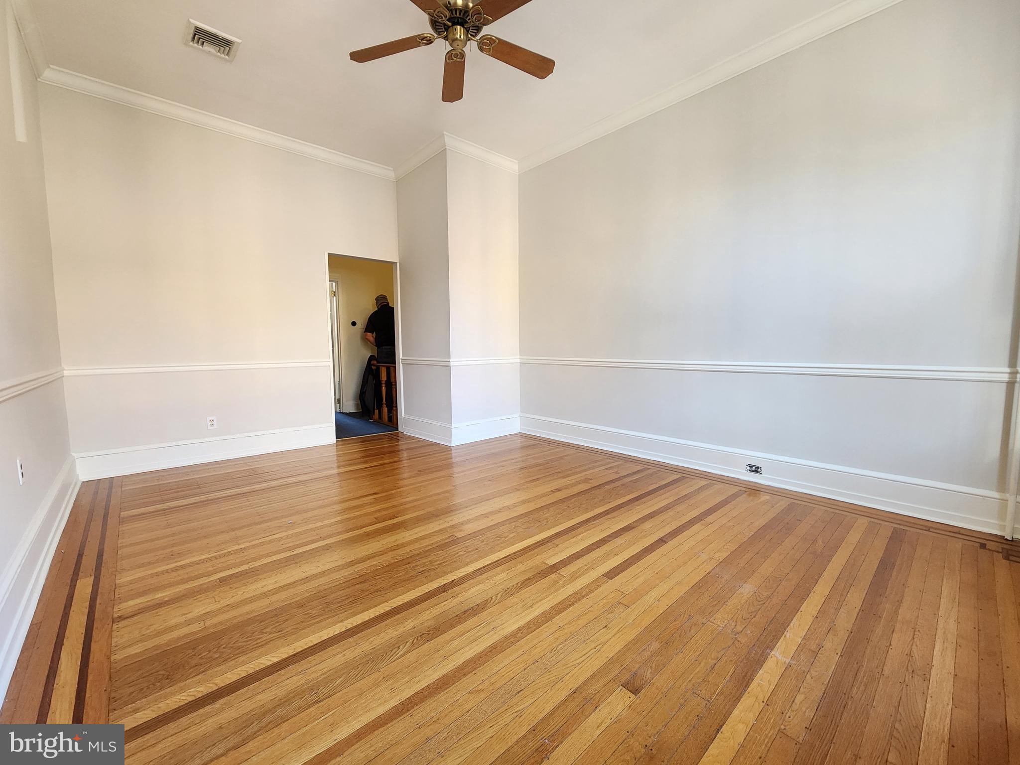4322 Main Street, Unit 2 Philadelphia, PA 19127 - Photo 6 of 27 an empty room with wooden floor and ceiling fan