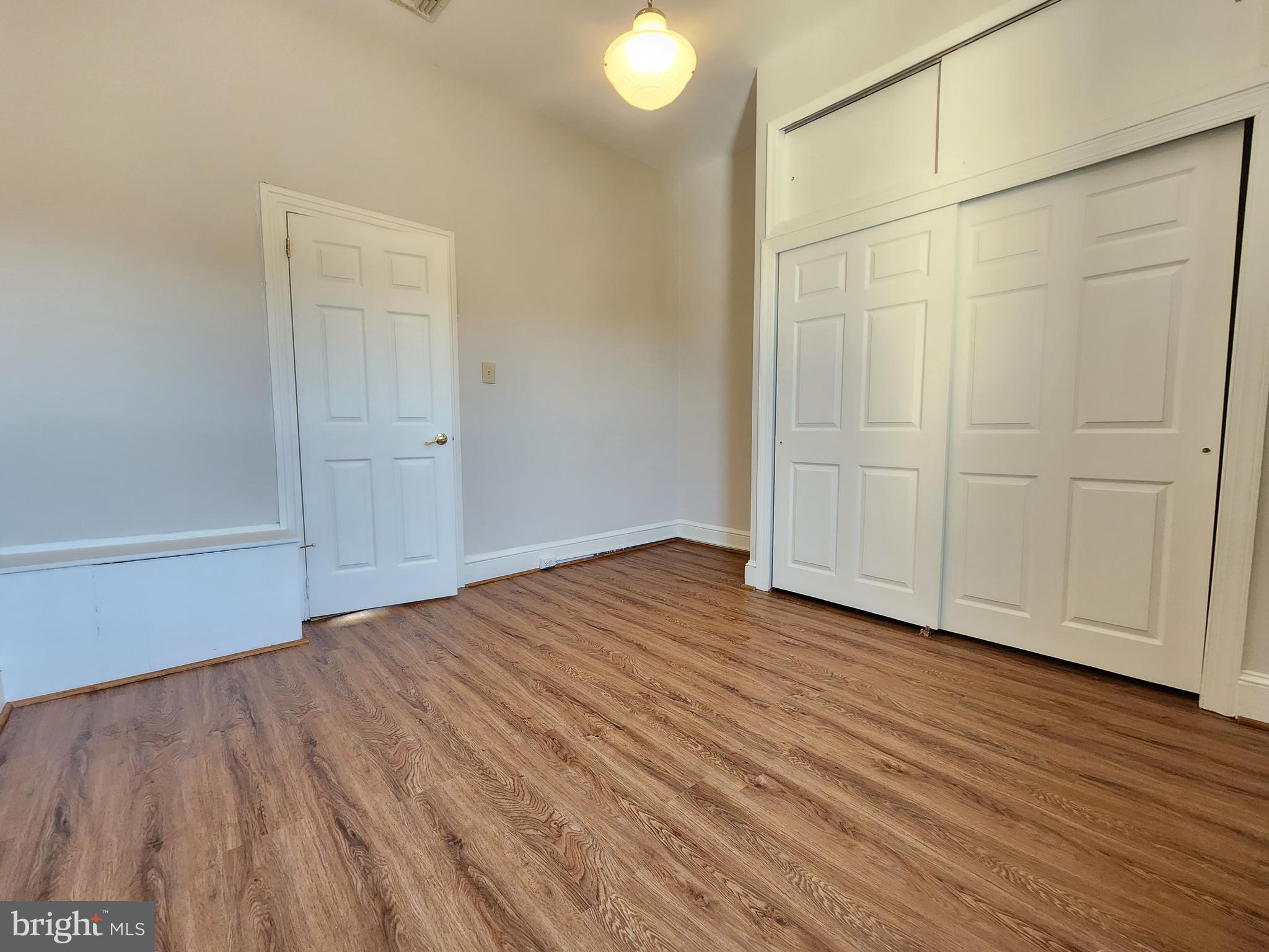 4322 Main Street, Unit 2 Philadelphia, PA 19127 - Photo 9 of 27 a view of an empty room with wooden floor and a window