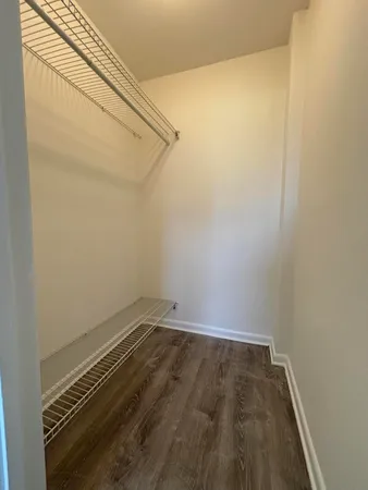 a view of a room with wooden floor