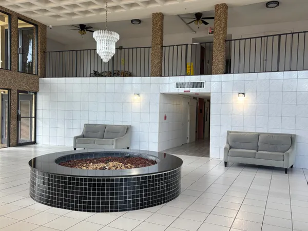 a living room with furniture a rug and a fireplace