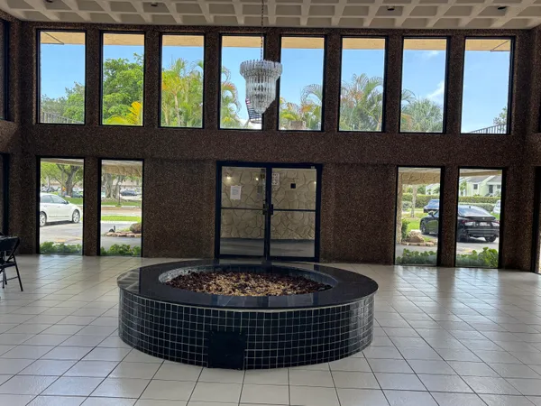 a living room with a fireplace and large windows