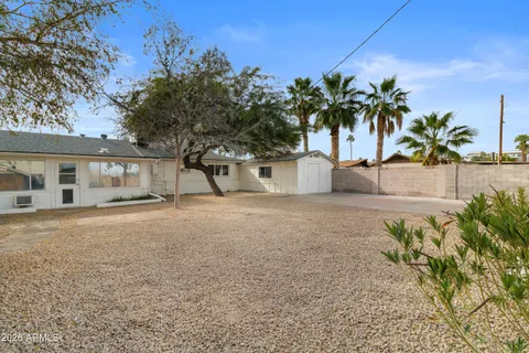 a front view of a house with a yard and a garden