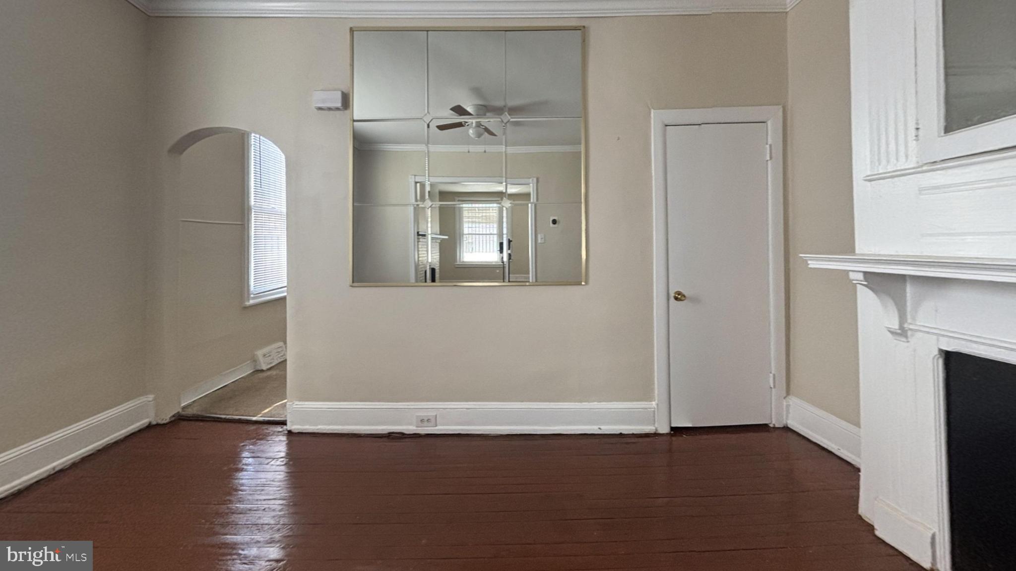 5471 Delancey Street Philadelphia, PA 19143 - Photo 3 of 9 an empty room with wooden floor and a window